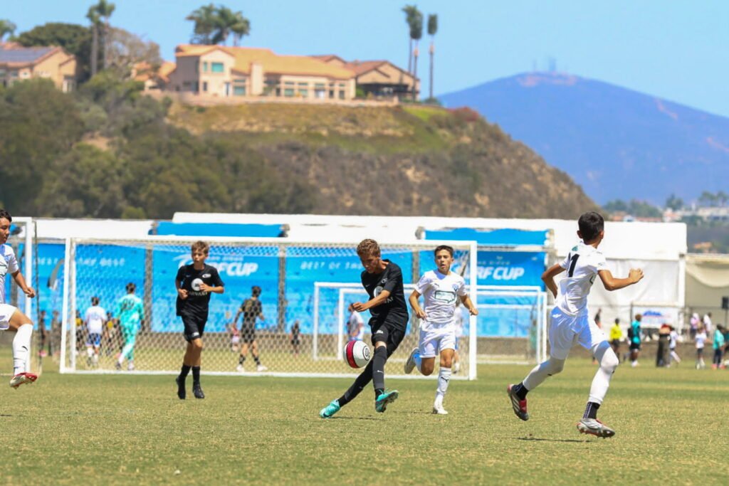 Youth soccer players converging on the ball during a match