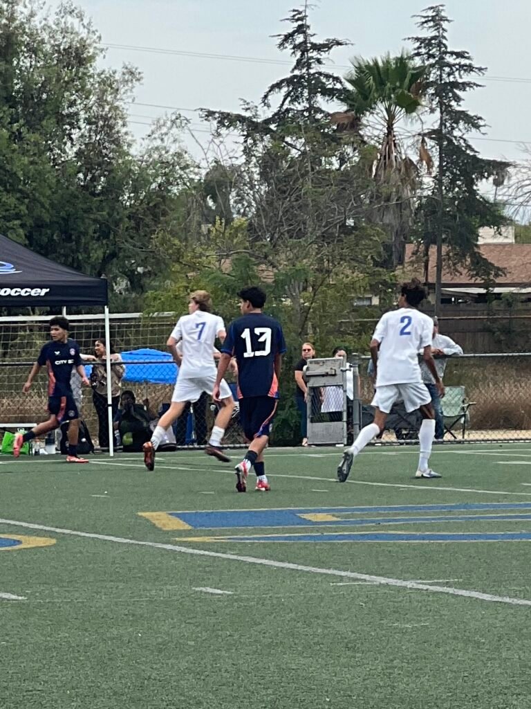 Youth soccer players tracking runners during a match